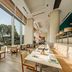 Holiday Inn Shanghai Pudong Kangqiao dining room with large windows overlooking trees and patio seating