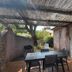 Résidence Les Cigales in Porto-Vecchio: shaded patio with table, chairs, and sliding glass door