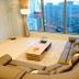 Marianne Hotel Busan lounge with curved sofa, floor lamp and city view through large windows