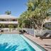 Atlantic Byron Bay pool terrace with sun loungers and palm trees in Byron Bay