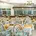 Neptune Beach Resort, Mombasa: airy restaurant with set dining tables, chandeliers, and buffet counter