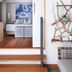 Elements of Byron, Byron Bay: bedroom with king bed, blue wall art, wood floors and decorative branch shelf