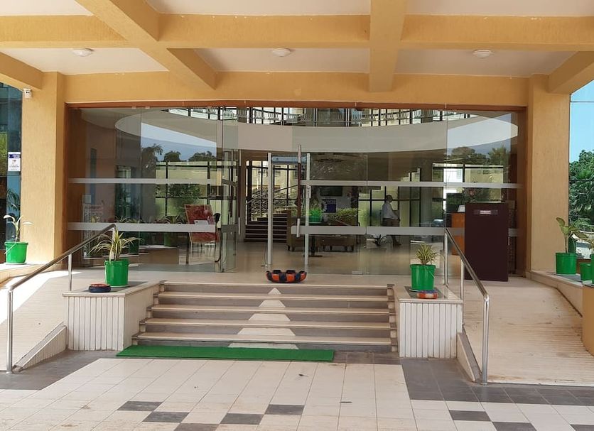 Seven Sky Clarks Exotica Bhuj hotel entrance with steps, glass doors and covered driveway