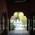 Hotel El Paraiso Escondido in Jacó with arched hallway opening to a pool and garden view