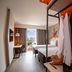 ibis Styles Lima Benavides Miraflores room with twin beds, desk, and open clothing rack in Lima