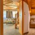 Hotel Leitenhof 4 Sterne Superior in Scheffau am Wilden Kaiser, cozy loft suite with wooden staircase and sofa