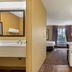 Extended Stay America Suites - Kansas City - Country Club Plaza room with kitchenette and bed by window
