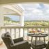 Acoya Curacao Resort, Villas & Spa balcony with wicker chairs and pool and garden views in Willemstad