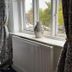 The Green Man, Rugby: guest room window with patterned curtains, radiator, and ceramic vase on the sill