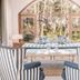 Kala Hotel Boutique in Maldonado seating area with striped armchairs and arched window garden view