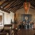 Four Seasons Safari Lodge Serengeti lobby with high thatched ceiling, chandelier and safari-inspired seating