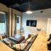 Old Mill Inn Hatfield lounge with leather sectional, wall-mounted TV and window seating