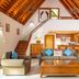 First Landing Beach Resort and Villas in Viseisei: airy villa living room with loft, staircase, and kitchen