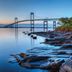 Club Wyndham Long Wharf in Newport with waterfront bridge and rocky shoreline