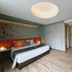 Samsen Street Hotel in Bangkok room with bed, modern lighting, and wood-look floor