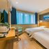 Super 8 by Wyndham Beijing Xi Zhi Men guest room with two twin beds and window seating in Beijing