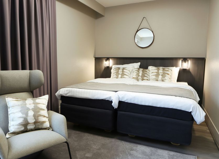 Original Sokos Hotel Rikala in Salo guest room with twin beds, armchair, and round wall mirror