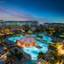 Kaya Palazzo Golf Resort in Belek with illuminated pools and resort buildings at dusk