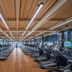 Beijing Lian Jie Hotel gym in Beijing with rows of treadmills and ellipticals on a wooden floor