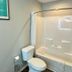The 409 Bolivar Beach Hotel bathroom with tub-shower combo and toilet in Bolivar Peninsula