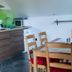 Rudi Hiti's Guest House in Bled kitchen area with wood cabinets and dining table