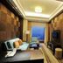 Shangmao International Hotel in Nanjing: suite with sofa, TV, bedroom, and city view