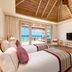 Milaidhoo Maldives guest room with ocean view, private deck and two beds in Kamadhoo