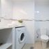 La Venecia de Canarias Puerto de Mogan bathroom with toilet, washing machine and white tiled walls in Mogán