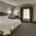 Hampton Inn & Suites Indianapolis-Airport room with king bed, desk, TV, window and chair in Indianapolis