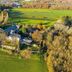 Château De Noirieux in Briollay, aerial view of the hotel surrounded by green fields and trees