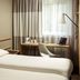 ibis London Barking guest room with twin beds, desk, laptop and window curtains in Barking