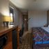 Super 8 by Wyndham Miles City guest room with queen bed, desk, and mini fridge