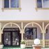 Hotel Altes Kurhaus in Ostseebad Baabe with arched facade, glass entrance, and front terrace