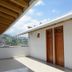Hotel Monarca in Itagüí: rooftop terrace with mountain and city view, white walls and wooden doors