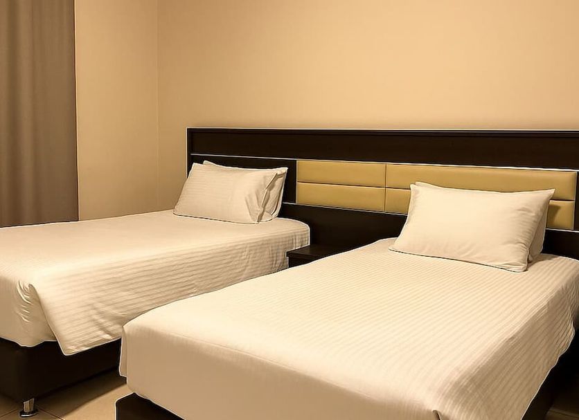 Panda Hotel Apartments in Amman twin bedroom with two single beds and padded headboard