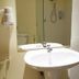 Justbeds Bangkok bathroom with wall-mounted hair dryer, sink and mirror