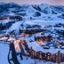 Waldorf Astoria Park City aerial view of a snowy resort village in Park City with mountain backdrop