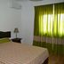 Monte das Palmeiras hotel room in Ferreira do Alentejo with double bed and green curtains