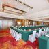 The Longemont Shenyang conference hall with U-shaped banquet seating and green tablecloths