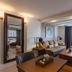 Marine Beach Hotel Pattaya in Jomtien, suite with sofa, coffee table and balcony curtains