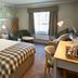 The Bluebird Inn at Samlesbury room in Blackburn with king bed, desk, window seat and lounge chair
