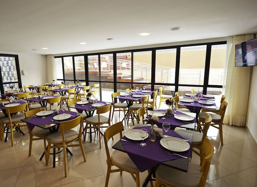 Transamerica Executive Natal dining room with set tables and large windows in Natal