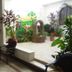Hotel Casa Vieja, Puerto Escondido courtyard with potted plants, mural, and brick archway