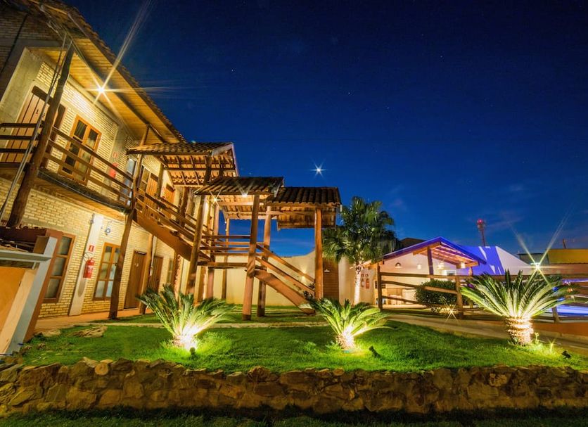 Pousada Muito Bonito in Bonito with illuminated lodge-style buildings and landscaped garden at night
