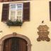 Hostellerie Seigneurs de Ribeaupierre in Ribeauvillé with arched wooden door, shuttered window and flower boxes