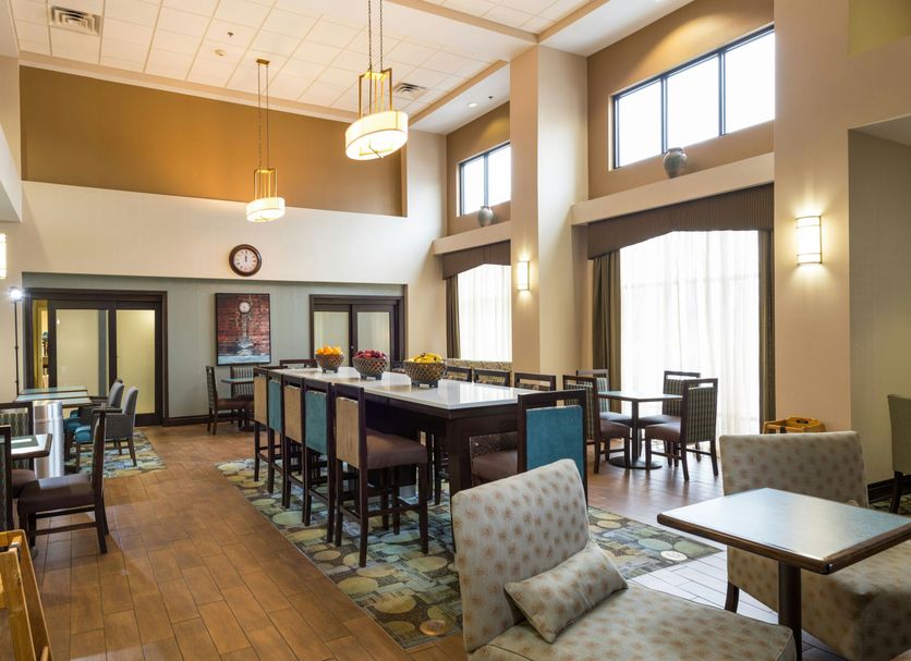 Hampton Inn and Suites Jamestown lobby breakfast area with high ceilings and tall windows