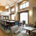 Hampton Inn and Suites Jamestown lobby breakfast area with high ceilings and tall windows