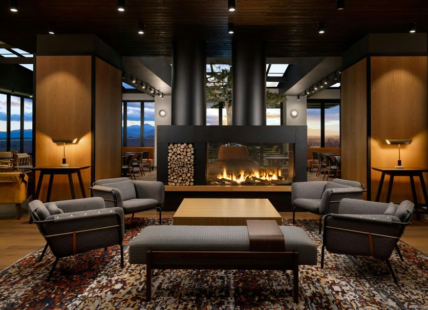 Moxy Asheville Downtown lobby lounge with fireplace, mountain views, and modern seating in Asheville