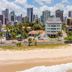 Intercity João Pessoa beachfront hotel with city skyline and palm trees in João Pessoa