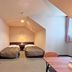 Hotel Sun Abashiri room with two twin beds, desk, and sloped ceiling in Abashiri